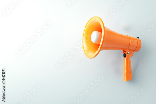 A vibrant orange megaphone against a light background, symbolizing communication and amplification of messages. photo