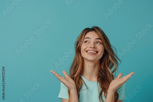 Cheerful girl with copy space ad solution on blue background.