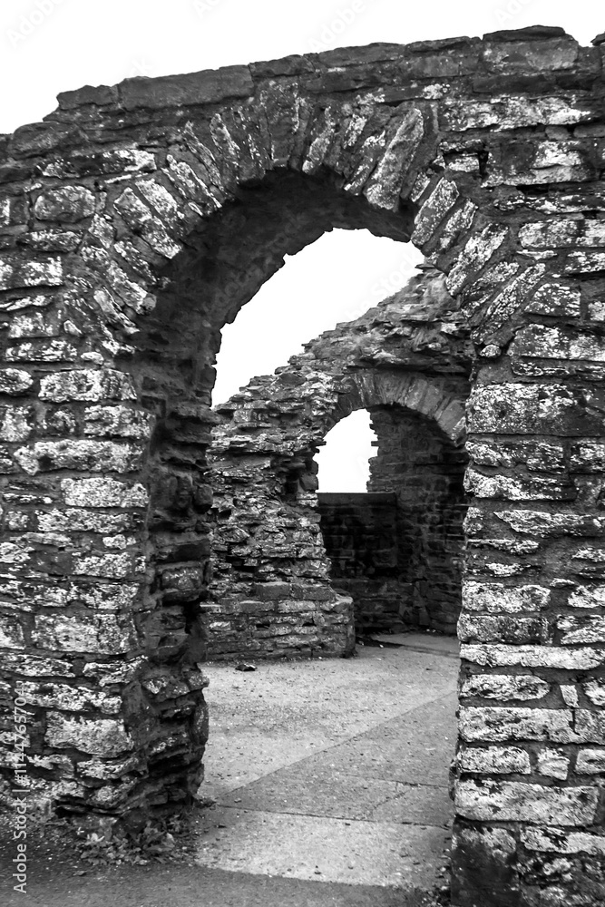 Fototapeta premium Open doors and Arches in black and white of an old Castle Ruin in Wales