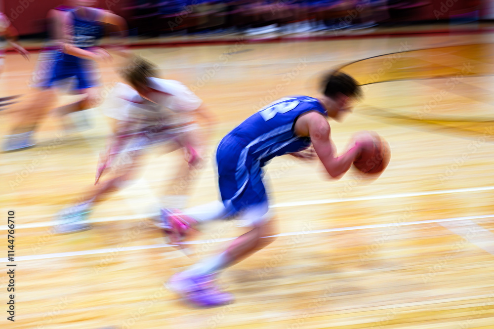 Naklejka premium High School Basketball with motion blur showing the speed and movement of the young boys playing the game at Oxford HS in Upstate NY