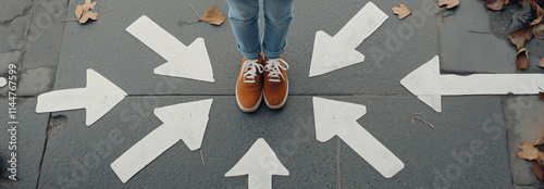 A person wearing brown shoes stands on pavement surrounded by large white arrows pointing in various directions, symbolizing decision-making or choices. photo