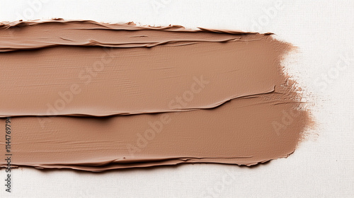 A trace of a brush with thick mocha mousse-colored paint. View from above. An empty space for the text.