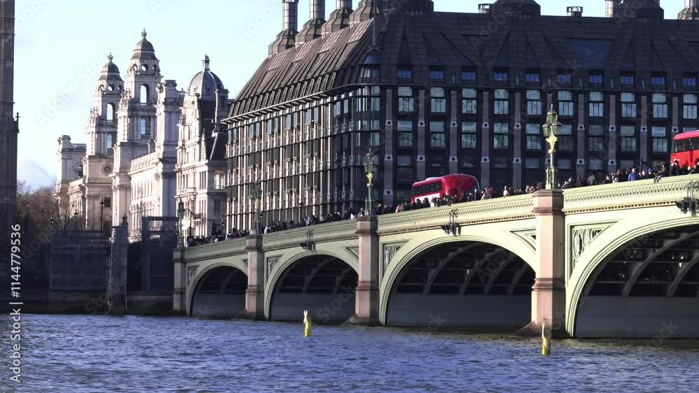 View of Westminster Bridge over the River Thames with red double decker buses and the Houses of Parliament in the background. View of Westminster Bridge over the River Thames with red double decker buses and the Houses of Parliament in the background.