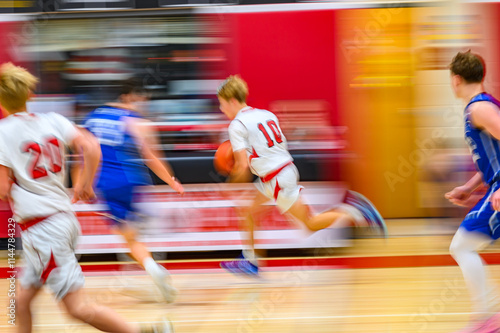 High School Basketball with motion blur showing the speed and movement of the young boys playing the game at Oxford HS in Upstate NY