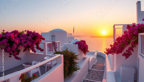 A house in front of sea around red flowers over sunset. the color of house in white