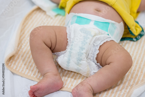 Newborn baby wearing wetness indicator diaper photo