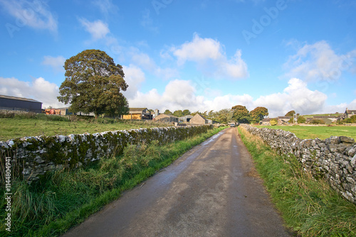 Country lane with dry stone walls either side photo