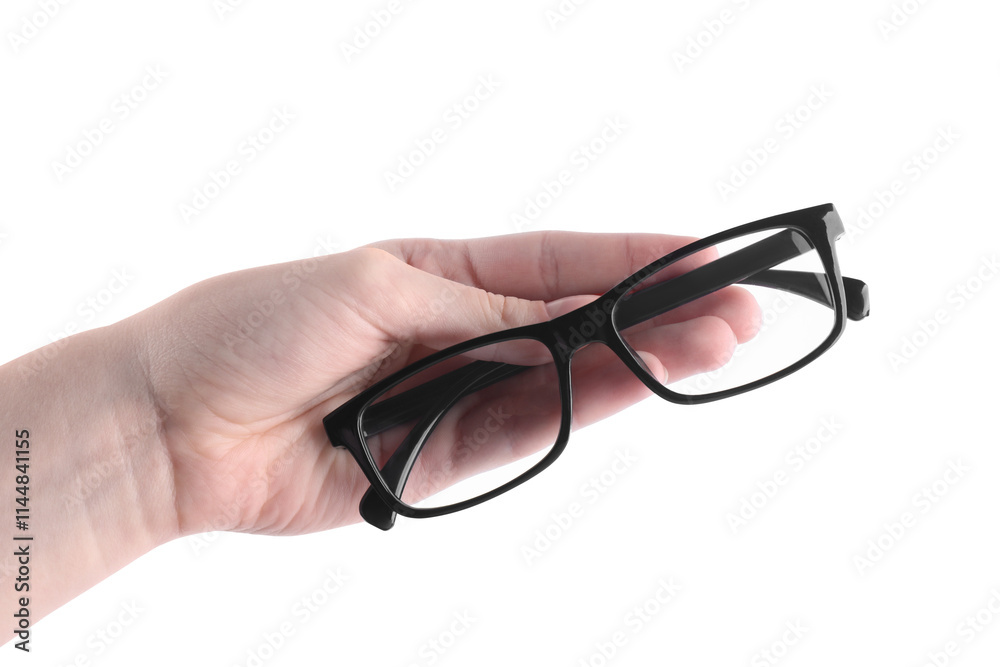 Woman holding glasses with black plastic frame on white background, closeup Woman holding glasses with black plastic frame on white background, closeup