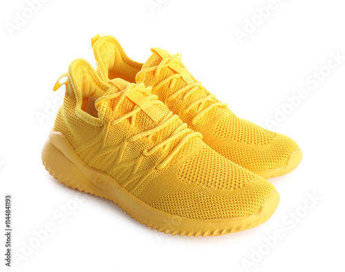Pair of stylish yellow sneakers isolated on white