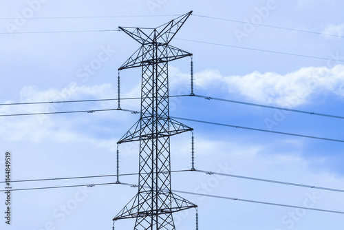 Photograph of the top section of an electricity Transmission Tower against a bright blue sky in regional Australia.