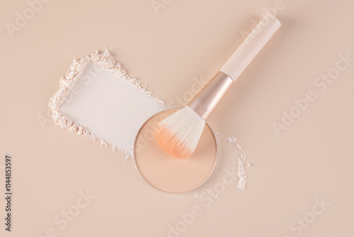 Top view of compact and loose powder with makeup brush