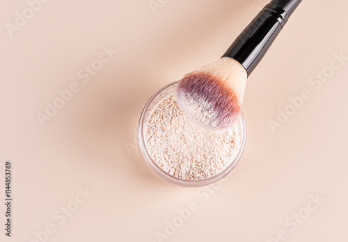 Brush dipped in loose powder, minimalistic beauty top view