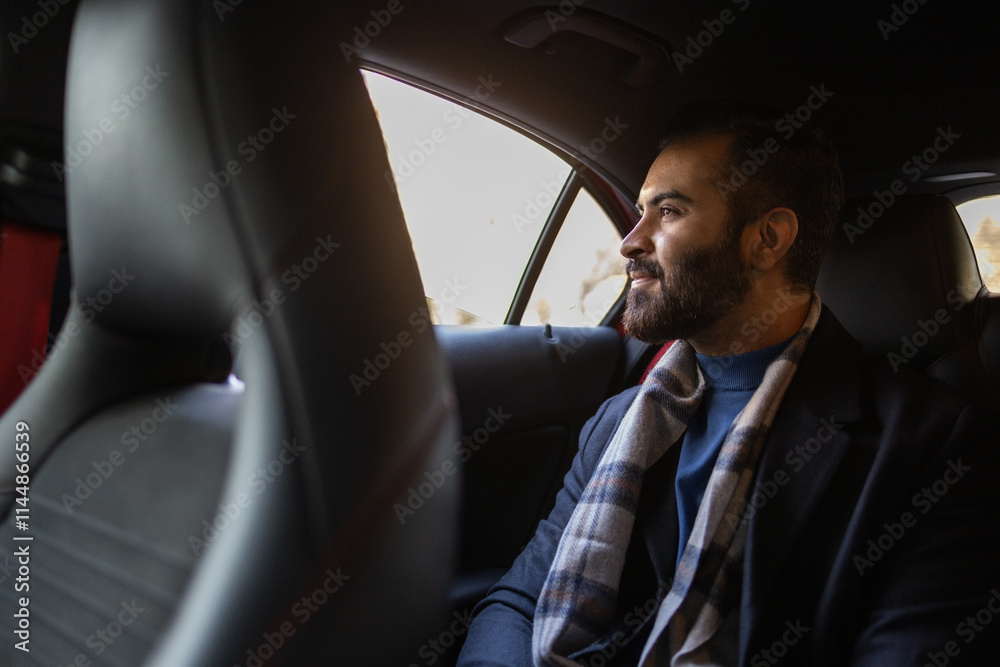 Indian businessman in warm attire traveling by car Indian businessman in warm attire traveling by car
