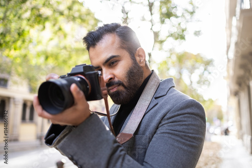 Indian photographer capturing a moment on a city street photo