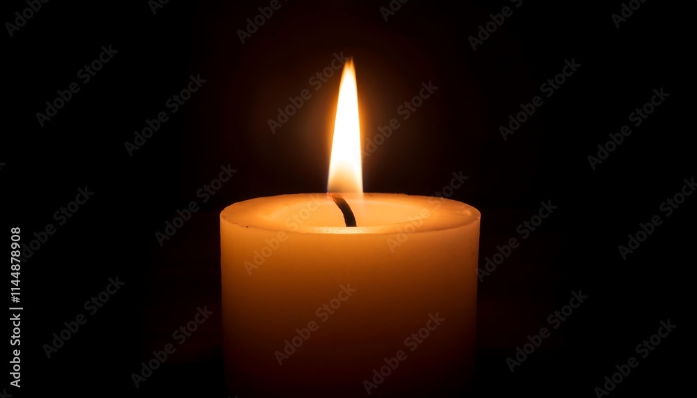A lit candle glowing in darkness. A lit candle glowing in darkness.