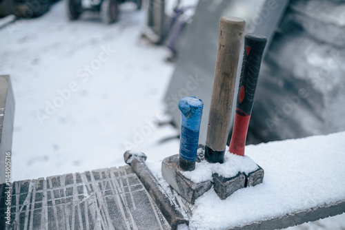 three hammers on working table outdoors. Carvers workshop in snowy winter day