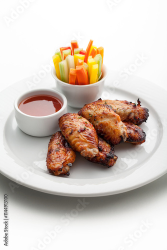grilled chicken wings with sauce and vegetables