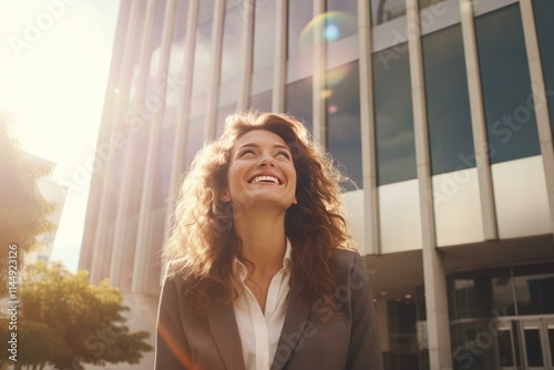 Happy businesswoman smiling looking up at the sky in a modern business district Free Download Happy businesswoman smiling looking up at the sky in a modern business district - GFXLoad