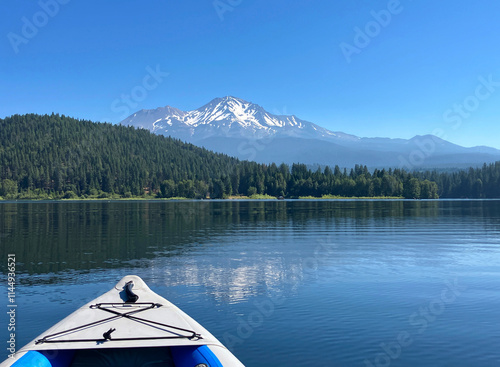Lake Siskiyou with forested shores and snow capped Mount Shasta as seen from an inflatable kayak