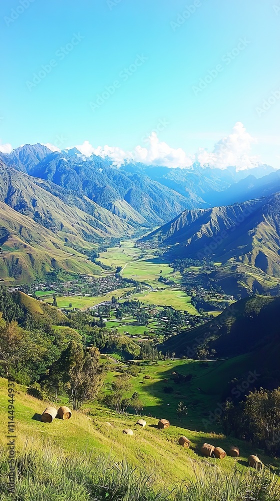 Obraz premium A breathtaking view of a lush valley surrounded by mountains under a clear sky.