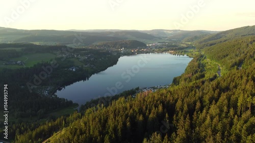 Aerial drone footage of flight along Lake Titisee in the Black Forest in Southern Germany at sundown