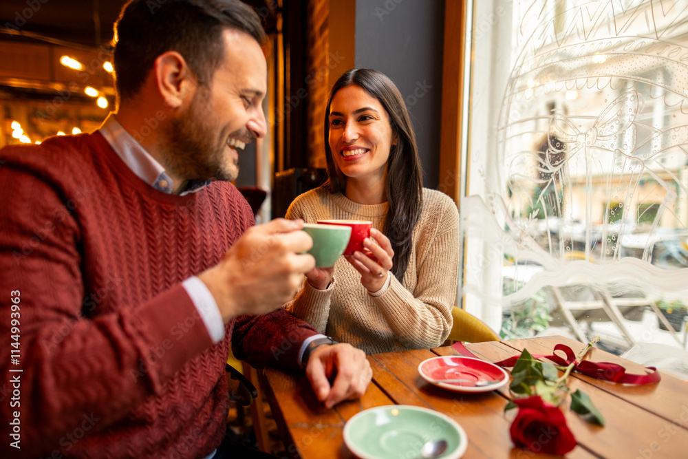 Caucasian mid adult couple, dressed in casual sweaters, enjoy a delightful coffee date in a warm cafe setting. They share this intimate moment, enhancing their Valentine's Day celebration. Caucasian mid adult couple, dressed in casual sweaters, enjoy a delightful coffee date in a warm cafe setting. They share this intimate moment, enhancing their Valentine's Day celebration.