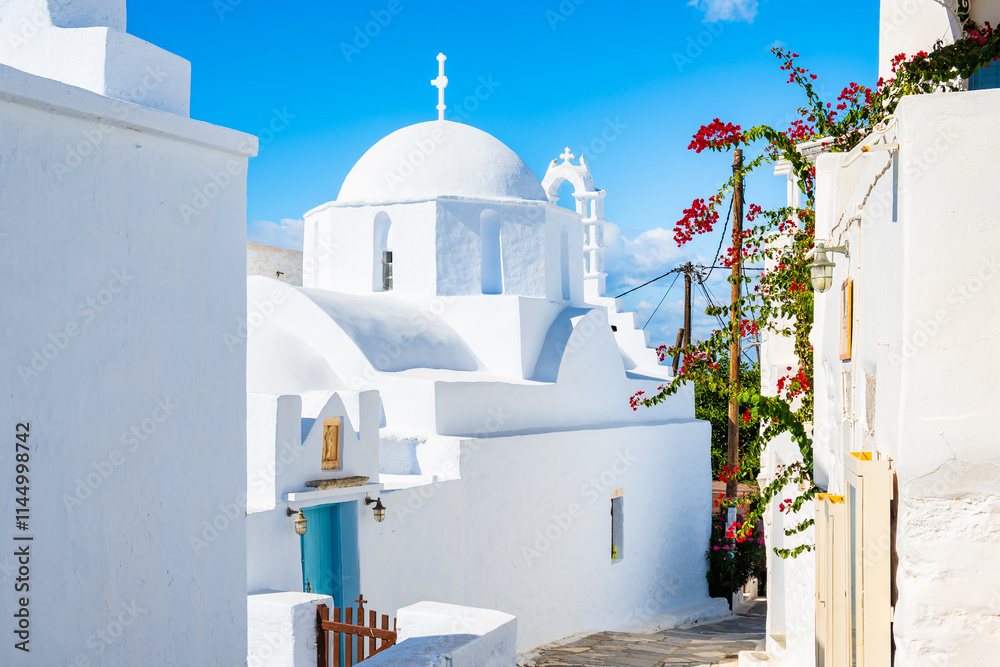 White church in narrow street of historic old part of Chora village, Amorgos island, Cyclades, Greece