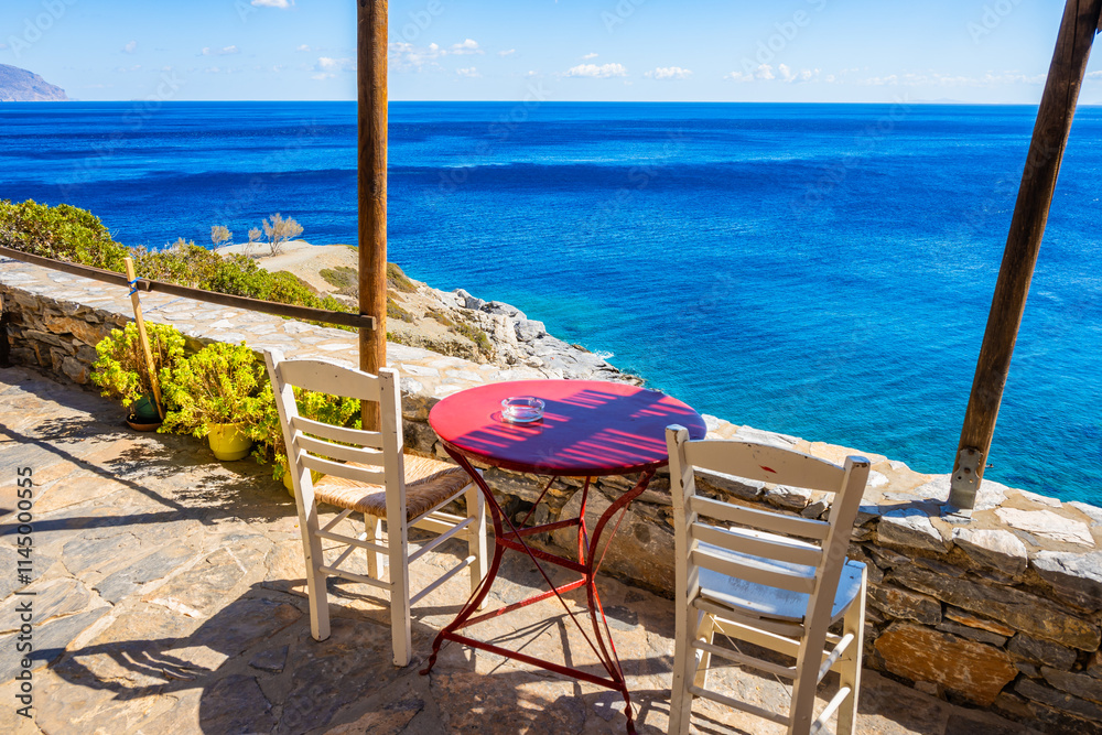 Two chair and table is small coffee bar on sea coast near Agia Anna beach, Amorgos island, Cyclades, Greece