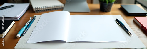 Blank paper and writing accessories are arranged in an organized manner on a cluttered office desk for planning purposes._00001_