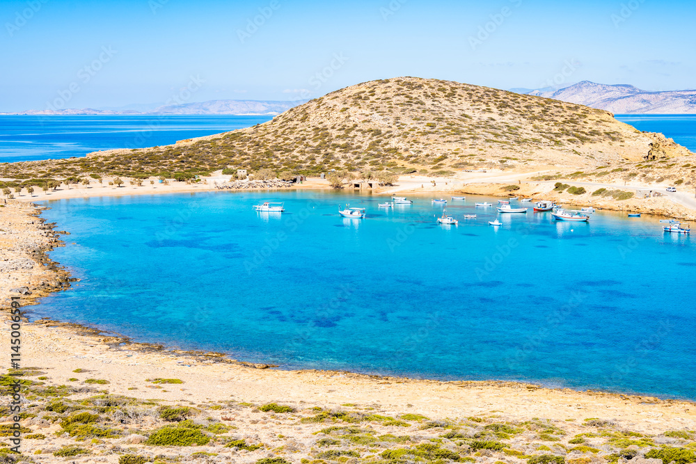 Boats in sea bay of Kalotaritissa with beautiful sandy beach, Amorgos island, Cyclades, Greece