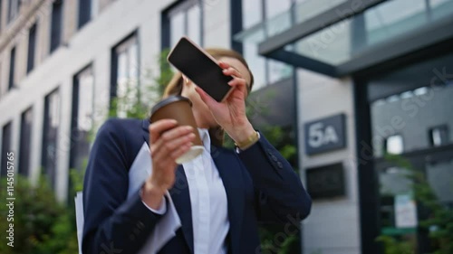 Overwhelmed businesswoman talking smartphone hurrying work with coffee closeup