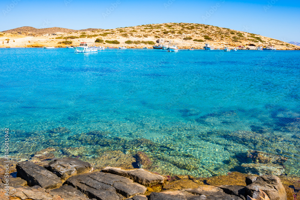 Boats in sea bay of Kalotaritissa with beautiful sandy beach, Amorgos island, Cyclades, Greece