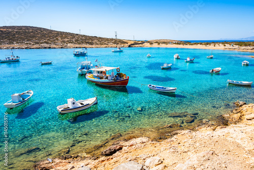 Boats in sea bay of Kalotaritissa with beautiful sandy beach, Amorgos island, Cyclades, Greece photo