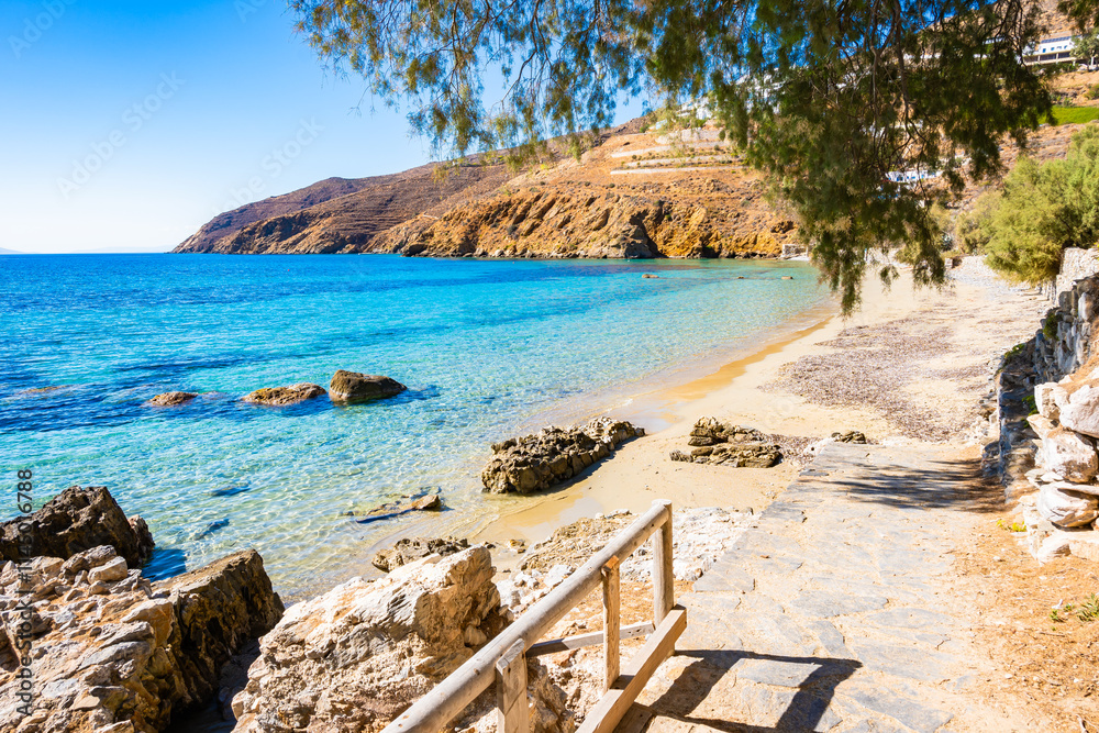 Small footbridge to beautiful sandy beach in Aigiali bay (Ormos Egialis), Amorgos island, Cyclades, Greece
