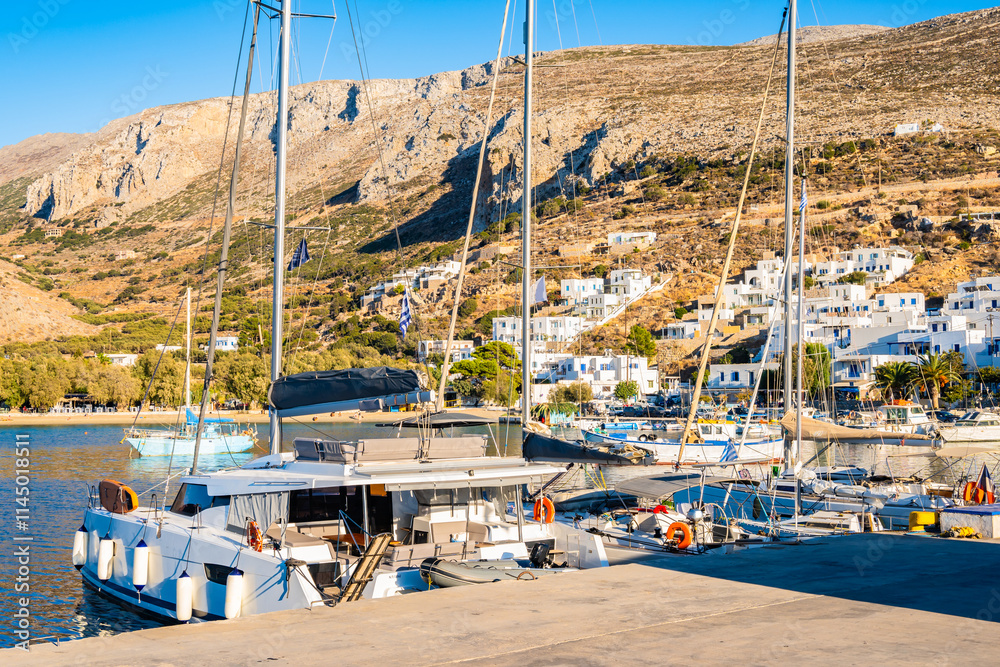 Sailing boats anchoring in Aigiali port (Ormos Egialis) at sunset, Amorgos island, Cyclades, Greece