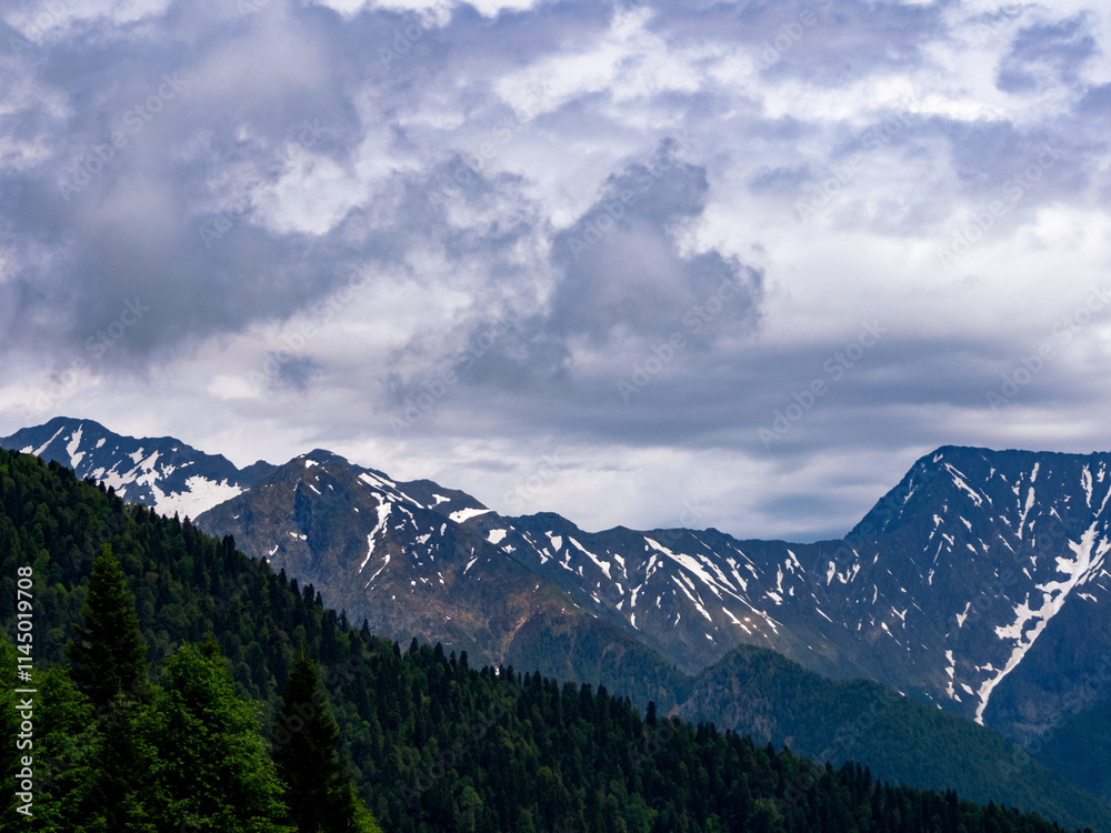 Fototapeta premium Close-up of mountain peaks adorned with snow caps, reflecting the power and beauty of the wild
