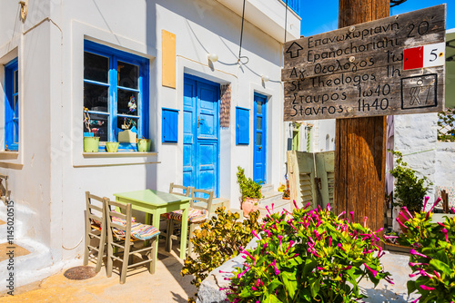 Obraz na płótnie Sign with time directions for tourists doing trekking trails in narrow street of Lagada village, Amorgos island, Cyclades, Greece w salonie