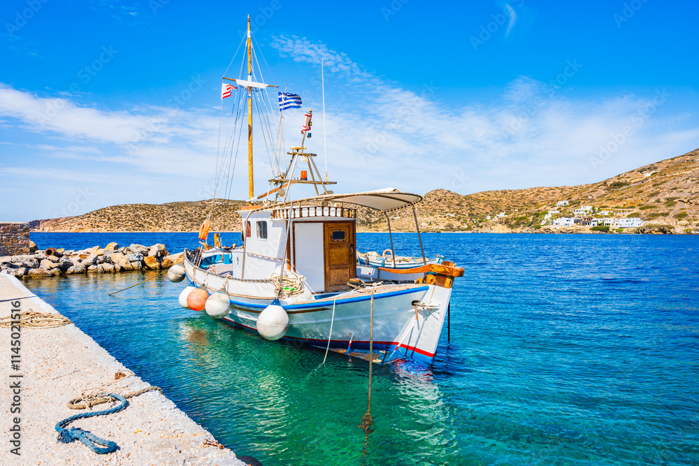Traditional fishing boat on blue sea in Katapola port, Amorgos island, Cyclades, Greece