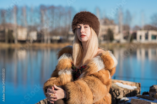 Slavic retro aesthetic. Portrait of a European type Blond head Young woman with natural skin in fur hat. photo