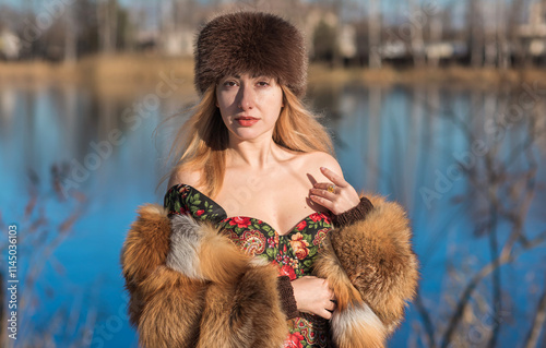 Slavic retro aesthetic. Portrait of a European type Blond head Young woman with natural skin in fur hat. photo