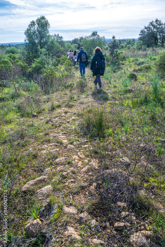 Group Walking Along Ancient Roman Road in Alosno, Spain photo