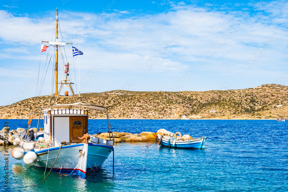 Traditional fishing boat on blue sea in Katapola port, Amorgos island, Cyclades, Greece