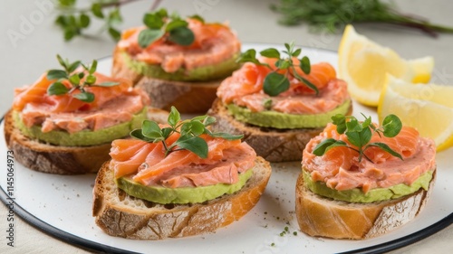 Wallpaper Mural A dish with smoked salmon and avocado tartare. Tartare is spread on slices of toasted bread. The top is decorated with lemon slices. Torontodigital.ca