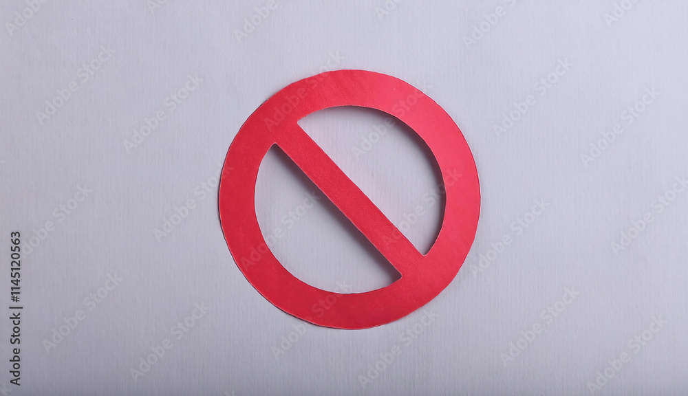Red prohibition sign cut out of paper on a gray background Red prohibition sign cut out of paper on a gray background