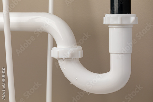 Картината върху платно Water dripping from leak on sink drain trap pipes