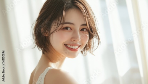 A beautiful Japanese woman with short hair smiles in front of white curtains. Free Download A beautiful Japanese woman with short hair smiles in front of white curtains. - GFXLoad