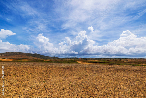 Desert landscape of Arikok National Park on island of Aruba under cloudy blue sky. photo