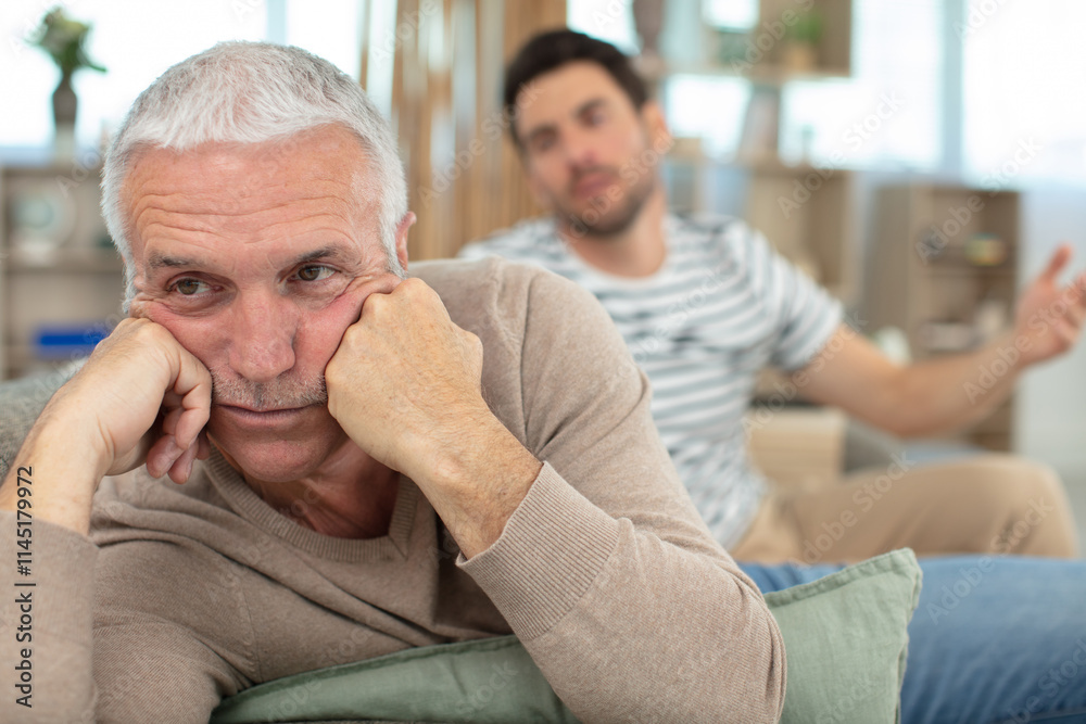 portrait of aging grieving man with his son