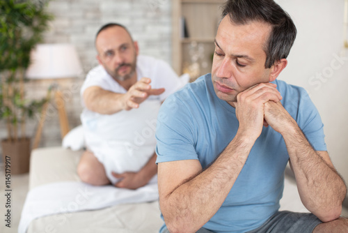 gay couple quarrels in bed