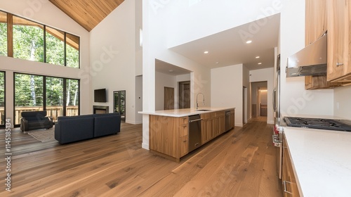 Modern open-plan kitchen and living area with high ceilings, hardwood floors, and large windows.